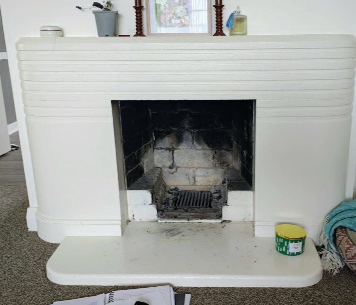A sooty, empty open art-deco fireplace before a wood fire was installed