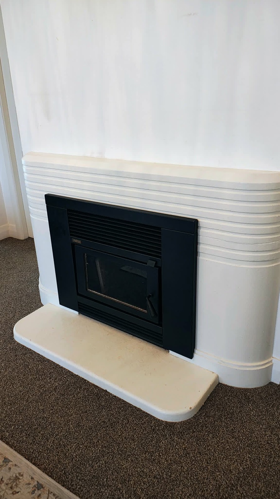 A clean, compliant inbuilt wood fire installed as a replacement by Premium Fires